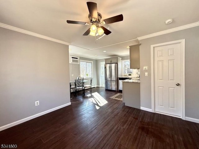 unfurnished living room with ornamental molding, dark wood-style flooring, a ceiling fan, and baseboards