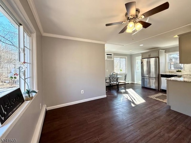 kitchen featuring freestanding refrigerator, dark wood-style flooring, crown molding, and baseboards