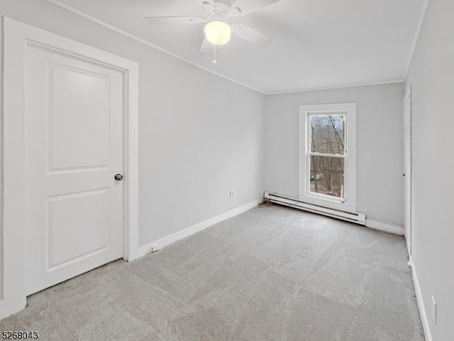 unfurnished room with a baseboard heating unit, carpet floors, baseboards, and a ceiling fan