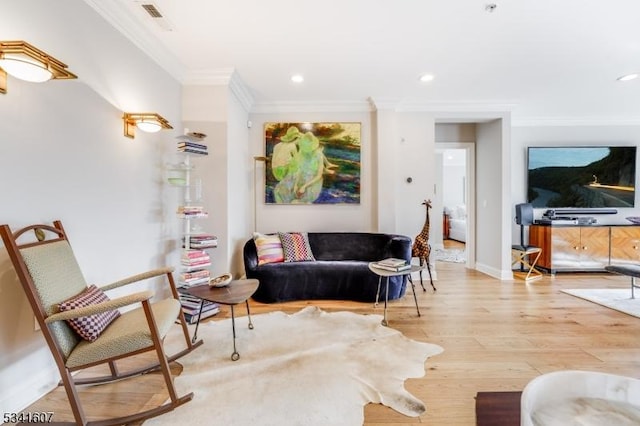 living room with ornamental molding, wood finished floors, visible vents, and recessed lighting