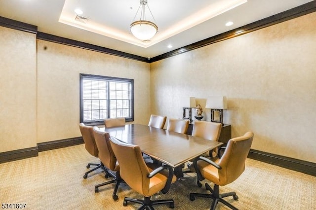 office area featuring carpet, baseboards, visible vents, and a tray ceiling