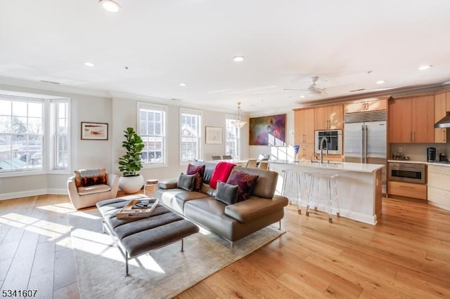 living area with light wood finished floors, recessed lighting, and a healthy amount of sunlight