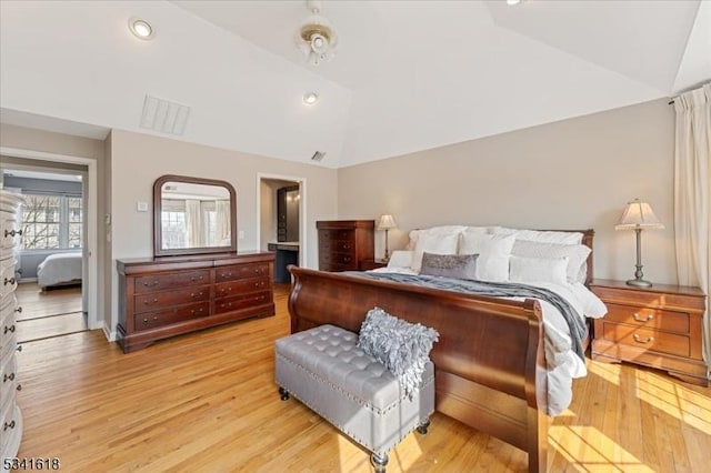 bedroom featuring lofted ceiling, light wood finished floors, visible vents, and recessed lighting