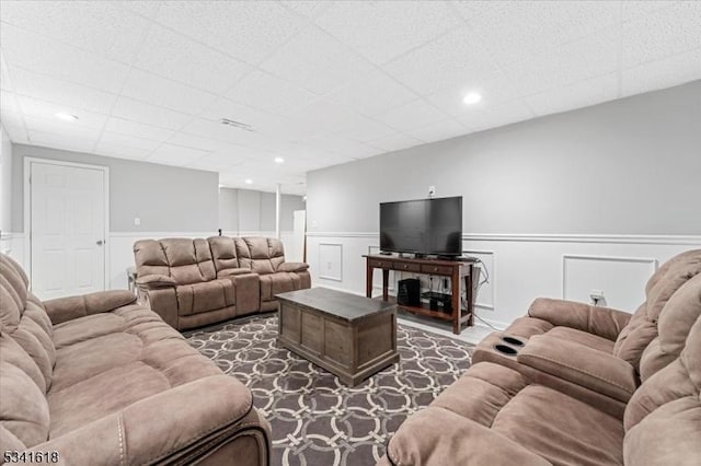 living room with recessed lighting, visible vents, and wainscoting