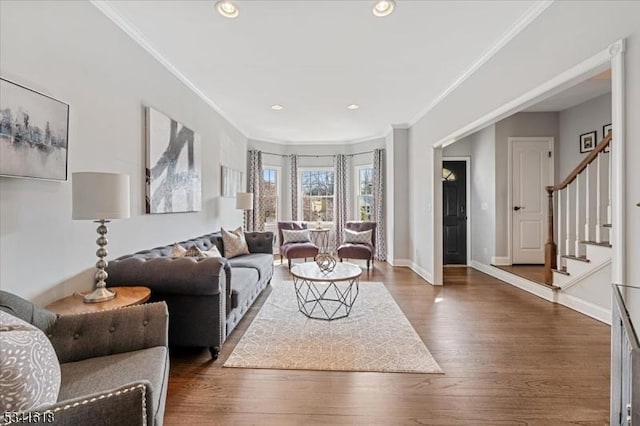 living area with stairway, wood finished floors, and ornamental molding