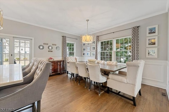 dining space featuring ornamental molding and a wealth of natural light