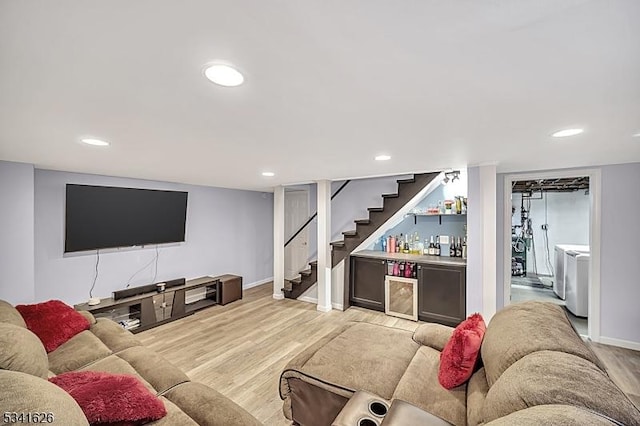 living area featuring a dry bar, stairway, light wood-style flooring, and recessed lighting