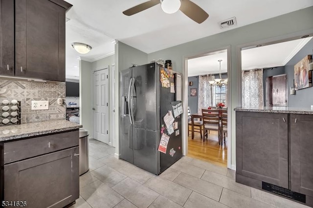 kitchen featuring dark brown cabinetry, visible vents, stainless steel refrigerator with ice dispenser, and crown molding