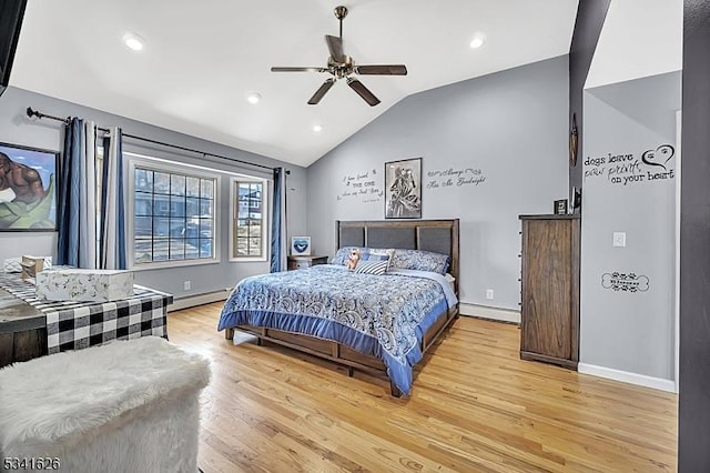 bedroom featuring lofted ceiling, light wood-style flooring, a baseboard heating unit, and baseboards