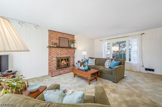 carpeted living room with a fireplace and visible vents