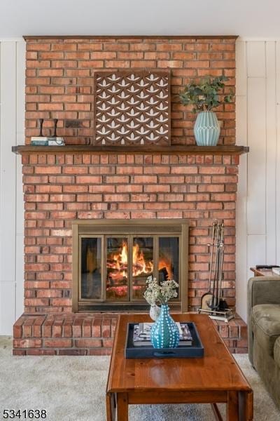 interior details featuring carpet floors and a fireplace