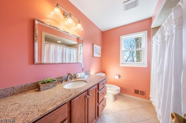 full bath featuring toilet, vanity, visible vents, and tile patterned floors