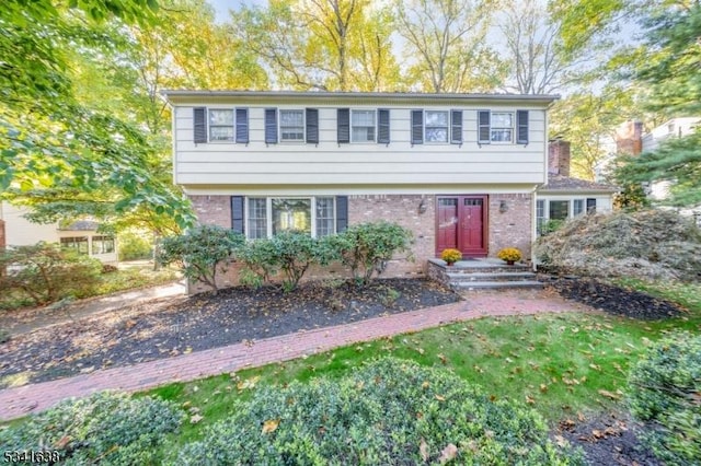 colonial inspired home with brick siding