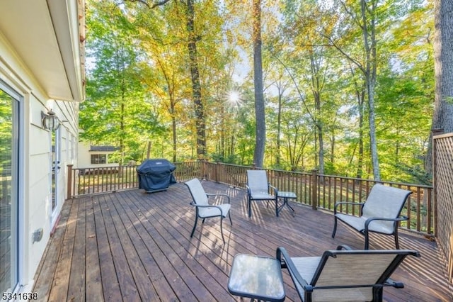 wooden deck featuring a grill