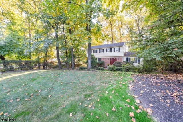 view of front of property with brick siding and a front yard