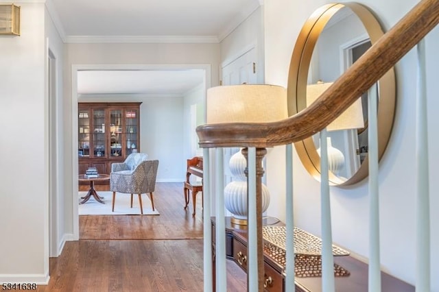 corridor with baseboards, ornamental molding, and dark wood-type flooring