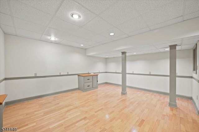 finished basement featuring light wood-style floors and baseboards