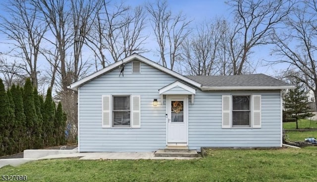 bungalow-style house featuring entry steps and a front yard