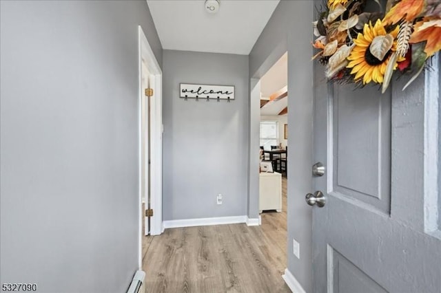 interior space featuring baseboards and wood finished floors