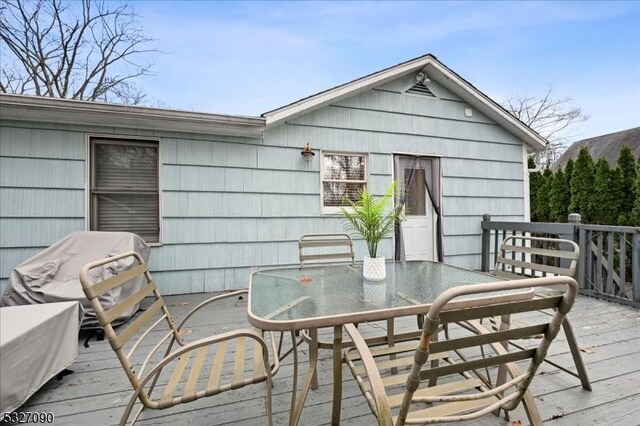 wooden deck with outdoor dining area