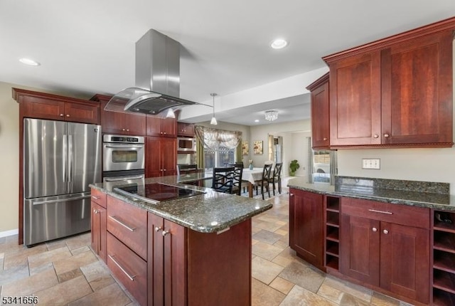 kitchen with appliances with stainless steel finishes, reddish brown cabinets, open shelves, island exhaust hood, and stone tile flooring