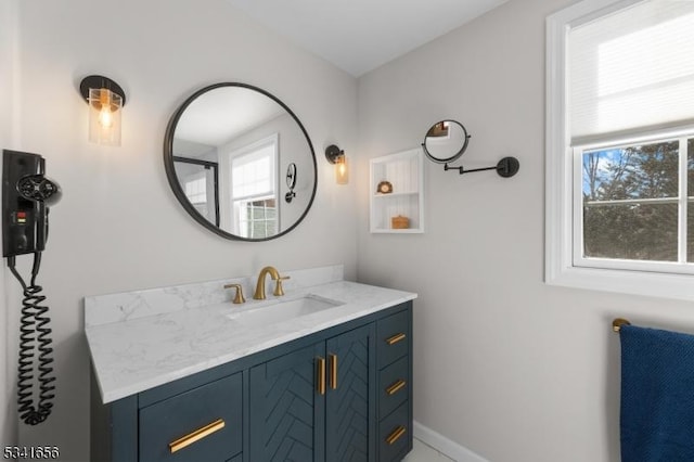 bathroom with vanity and baseboards