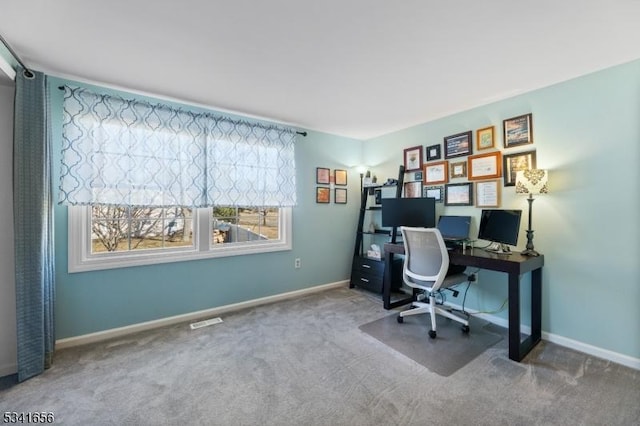 carpeted office with visible vents and baseboards