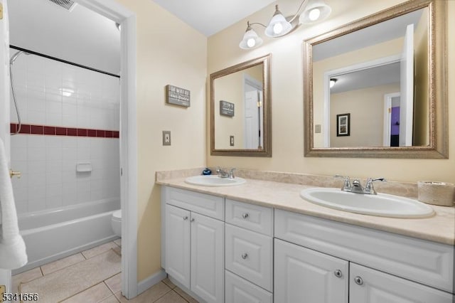 full bath featuring tile patterned flooring, a sink, toilet, and double vanity