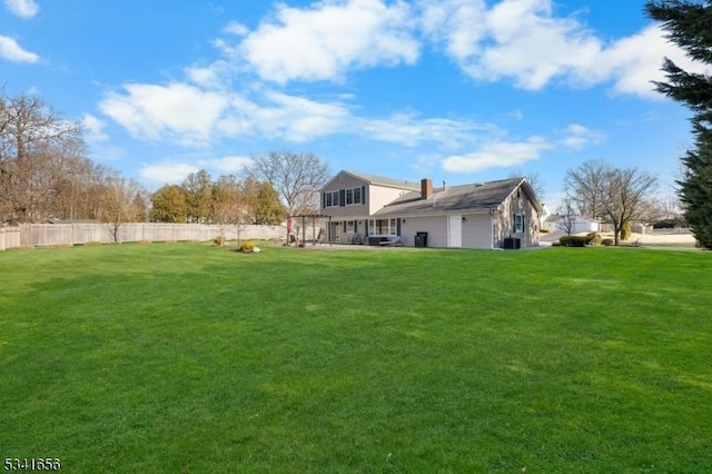 view of yard featuring central air condition unit and fence