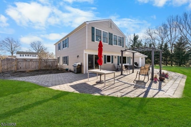 back of property with a patio, a yard, fence, and a pergola