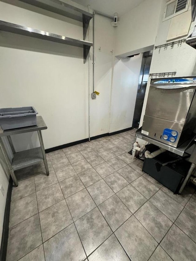 interior space with tile patterned flooring, visible vents, and baseboards