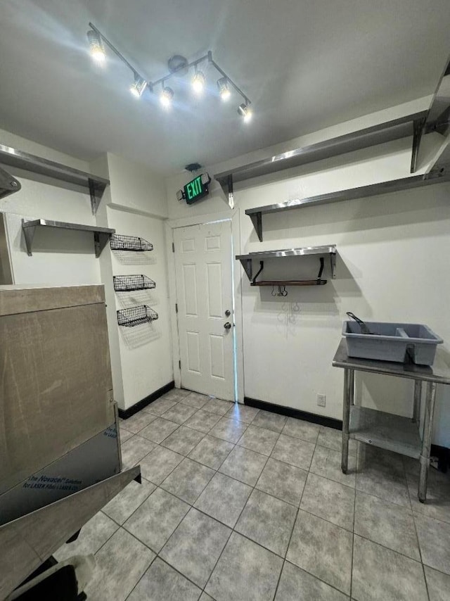 kitchen featuring open shelves, baseboards, and light tile patterned floors