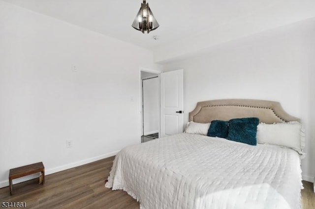 bedroom featuring wood finished floors and baseboards