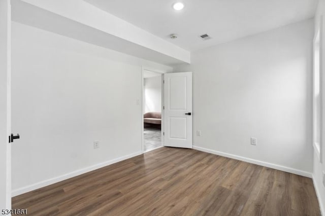 unfurnished bedroom with recessed lighting, visible vents, baseboards, and wood finished floors