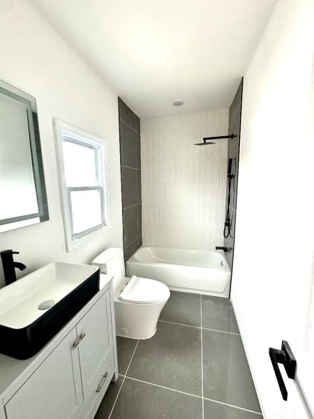 full bath with tile patterned flooring, toilet, vanity, and shower / tub combination