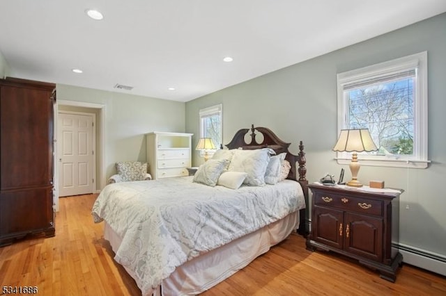 bedroom featuring light wood-style floors, a baseboard radiator, visible vents, and recessed lighting