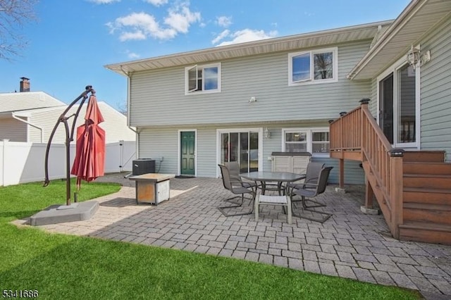 rear view of property with a patio, central AC unit, and fence