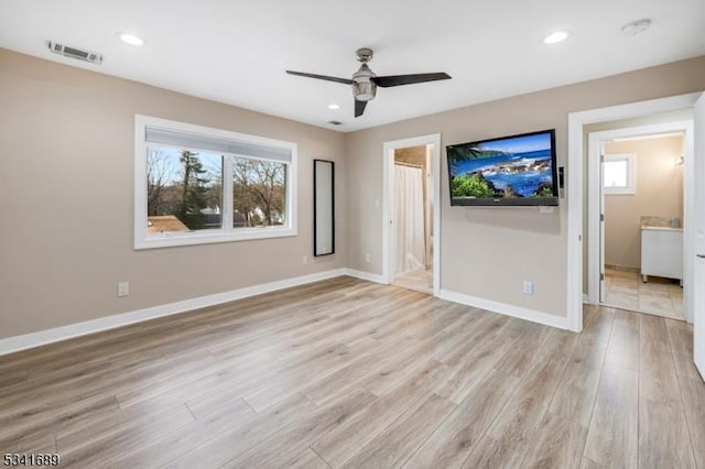 unfurnished room featuring recessed lighting, light wood-type flooring, visible vents, and baseboards