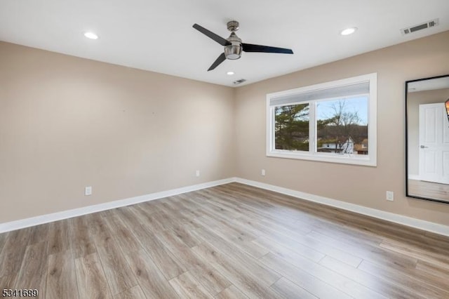 spare room with light wood-style flooring, recessed lighting, visible vents, and baseboards