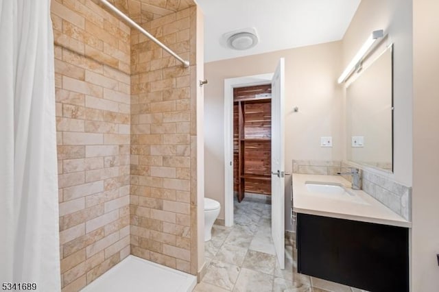 bathroom with a stall shower, marble finish floor, vanity, and toilet