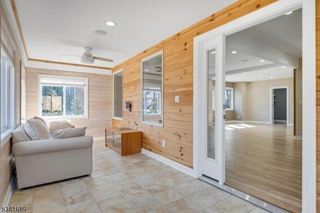 sunroom / solarium featuring ceiling fan