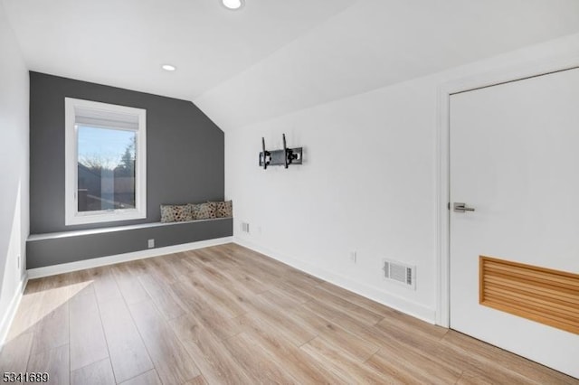 additional living space featuring lofted ceiling, light wood-type flooring, visible vents, and recessed lighting