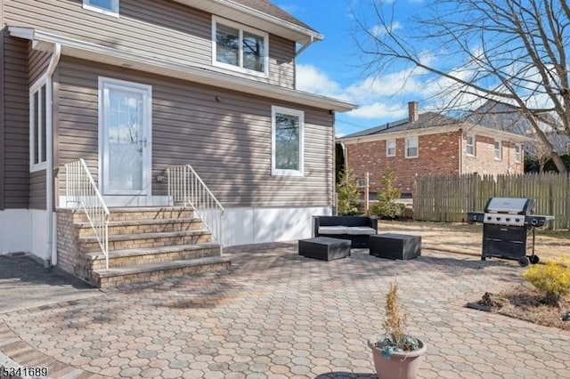 rear view of property with a patio, fence, and an outdoor living space