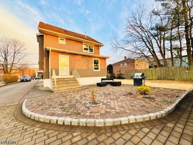 back of house with a patio area and fence