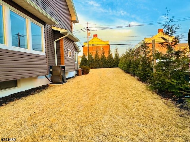 view of yard with central air condition unit