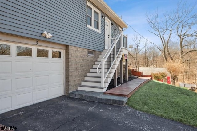 view of home's exterior with driveway and stone siding