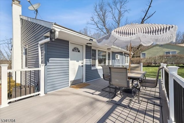 wooden terrace with outdoor dining space