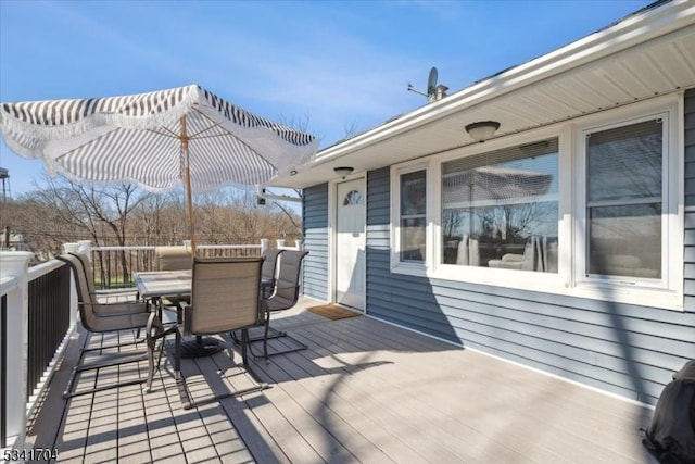 wooden terrace with outdoor dining space