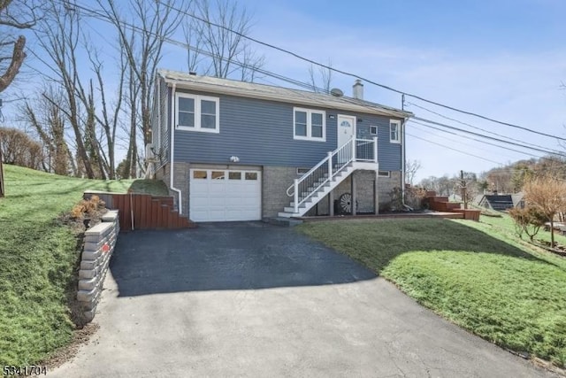 view of front of property featuring a garage, a chimney, stairway, aphalt driveway, and a front lawn