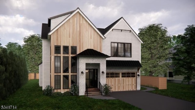 view of front of property with a front yard, a standing seam roof, metal roof, a garage, and driveway